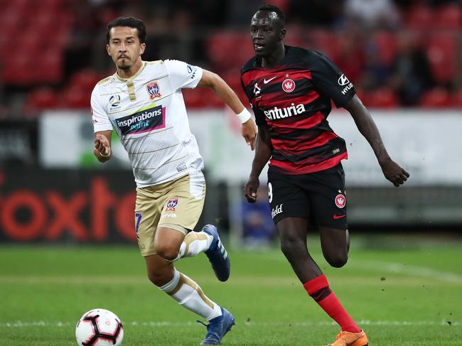 The Wanderers’ Manyiel Riel Majok is pursued by Newcastle’s Daniel Georgievski on Friday night. Picture: Getty Images