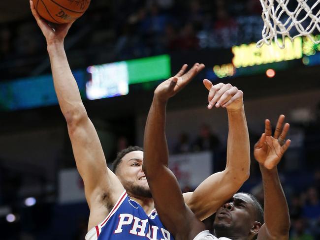 Ben Simmons shows off the difference in length he enjoys over regular-sized NBA point guards like New Orleans’ Jrue Holiday. (AP Photo/Gerald Herbert)