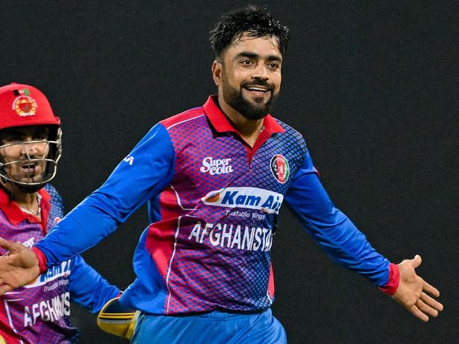 Afghanistan's Rashid Khan (R) celebrates with teammates after taking the wicket of Sri Lanka's Dasun Shanaka during the third one-day international (ODI) cricket match between Sri Lanka and Afghanistan at the Pallekele International Cricket Stadium in Kandy on November 30, 2022. (Photo by Ishara S. KODIKARA / AFP)