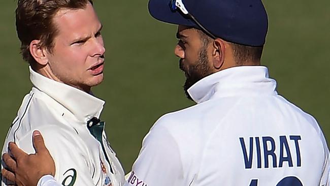 Australia's Steve Smith (L) talks with India's Virat Kohli on the third day of the first cricket Test match between Australia and India in Adelaide on December 19, 2020. Photo by William WEST / AFP