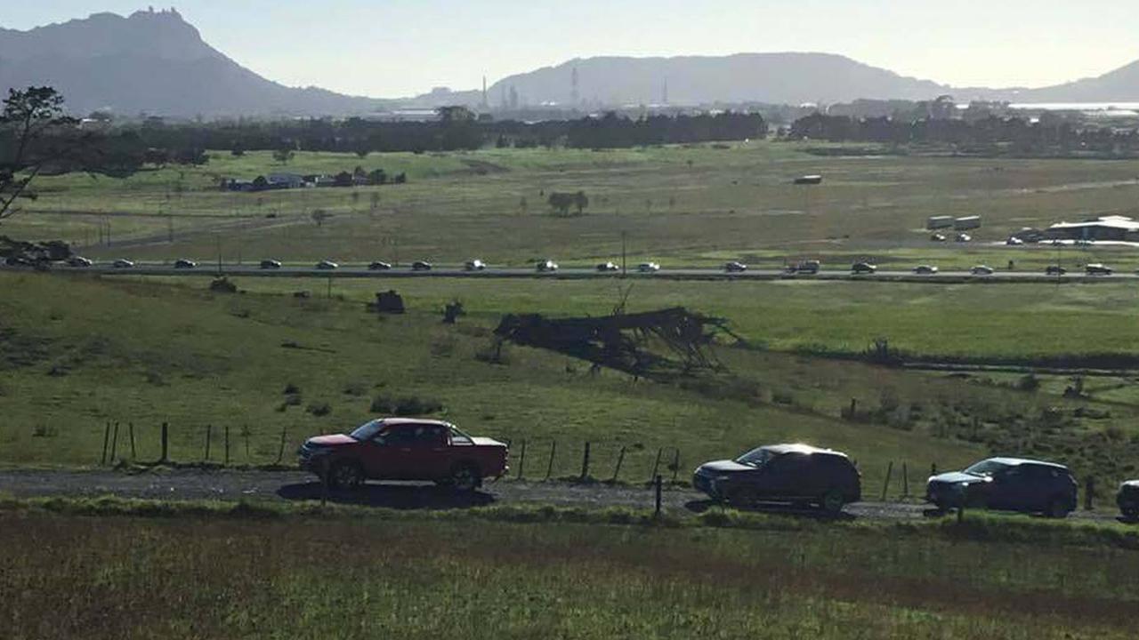 A procession of cars head to higher ground at One Tree Point near Whangarei harbour. Picture: Liz Hedley