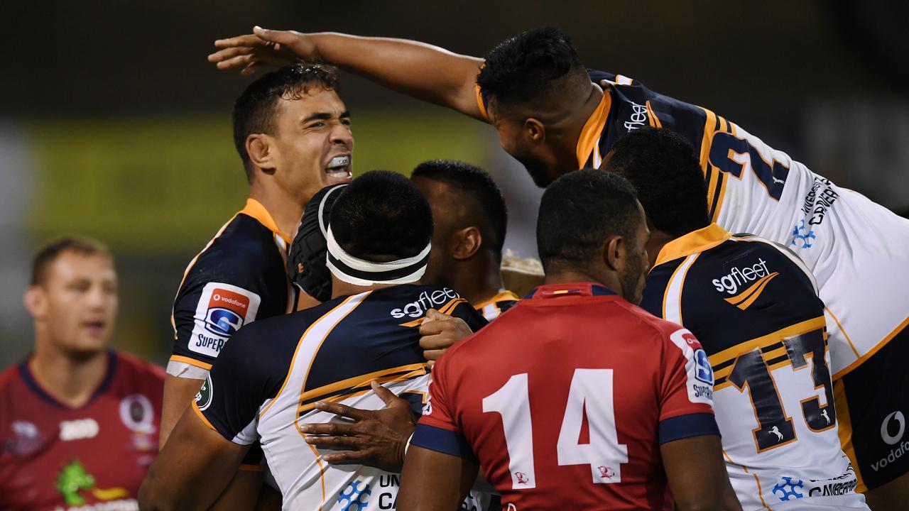 Rory Arnold of the Brumbies celebrates with teammates after scoring a try.