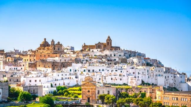 8/11Most unique: Ostuni, Puglia    More reminiscent of Greece than    Italy, Ostuni in Italy’s southern    Puglia region is best known for its whitewashed old town that looks like it leapt straight out of a fairytale. The stark contrast of its jumbled, tonal white buildings and the verdant olive trees surrounding it make it one of Italy’s most beautiful medieval cities. It’s perched high on a hill, so you can soak up panaromas of the countryside and Adriatic Sea from most aspects. 