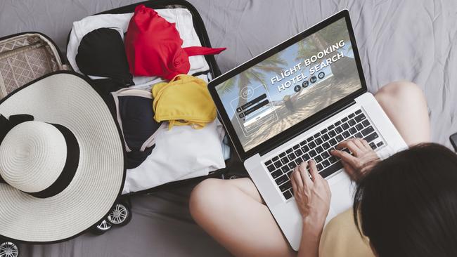 Top view Asian happy woman plan for trip by laptop booking hotel on the bed at home. Women with travel bag use notebook computer internet booking hotel. Holiday summer vacation concept,Escape 23 April 2023Doc HolidayPhoto -  iStock