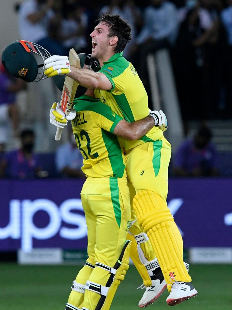 Glenn Maxwell embraces Mitch Marsh. (Photo by Aamir QURESHI / AFP)