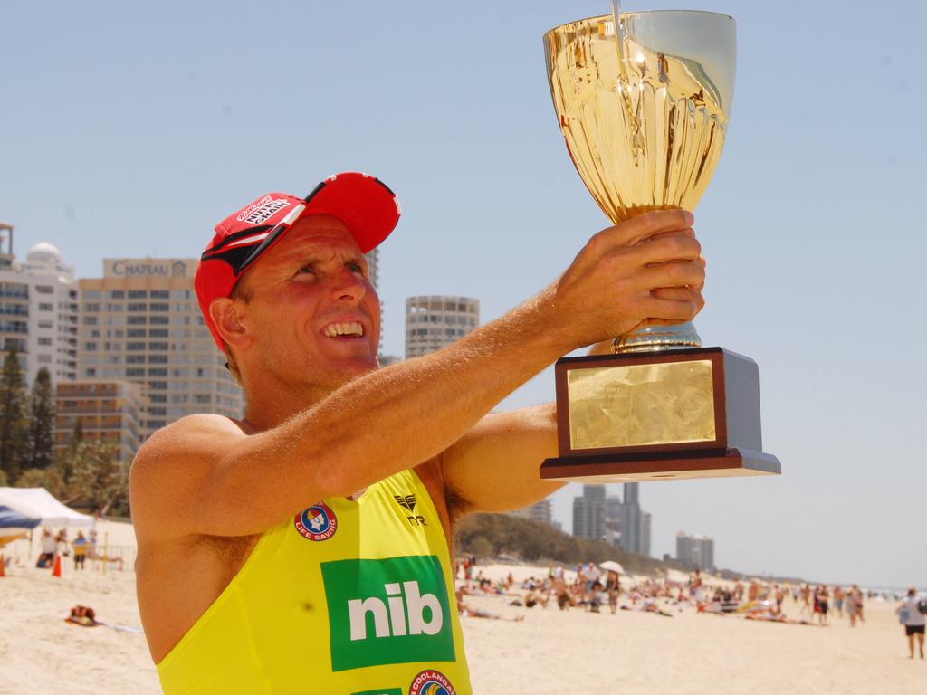 Ironman Dean Mercer holds the Coolangatta Gold trophy