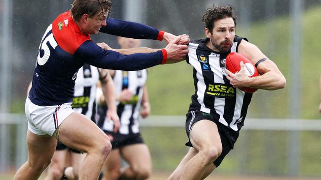 TSL match between Glenorchy v North Hobart from KGV. Glenorchy's Sam Rundle palms off North Hobart's Jack Sandric. Picture: Zak Simmonds