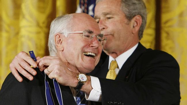 John Howard receives his medal from George W. Bush in 2009.