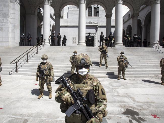 Members of California National Guard stand guard outside the City Hall in Los Angeles. Picture: AP