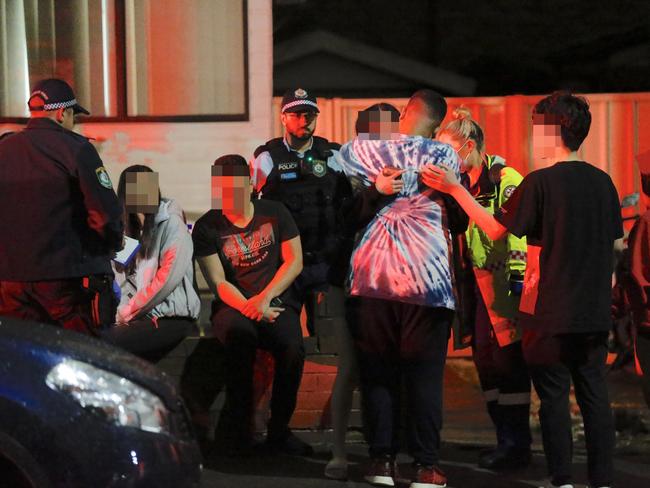 Friends of those affected by a drug overdose at Lidcombe last week wait outside the property for news from police. Picture: Steve Tyson