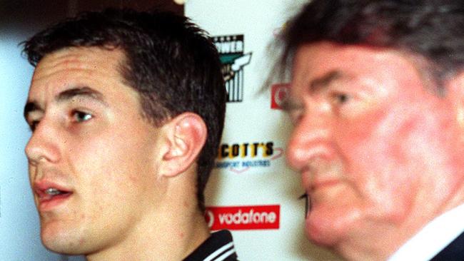 Port Adelaide Power Football Club chief executive Brian Cunningham with footballer Warren Tredrea and Geof Motley at press conference after Tredrea signed long-term contract.