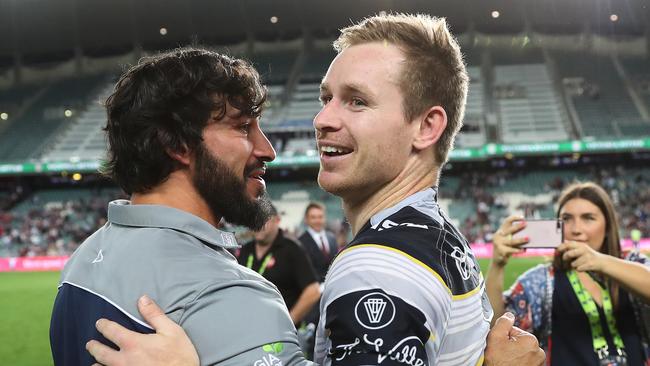 Michael Morgan celebrates a victory with Johnathan Thurston.