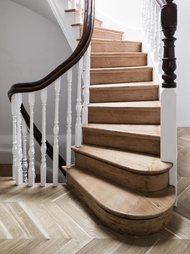 <b>AFTER:</b> The staircase was stripped back to its original wood and the chevron parquetry floor was added.