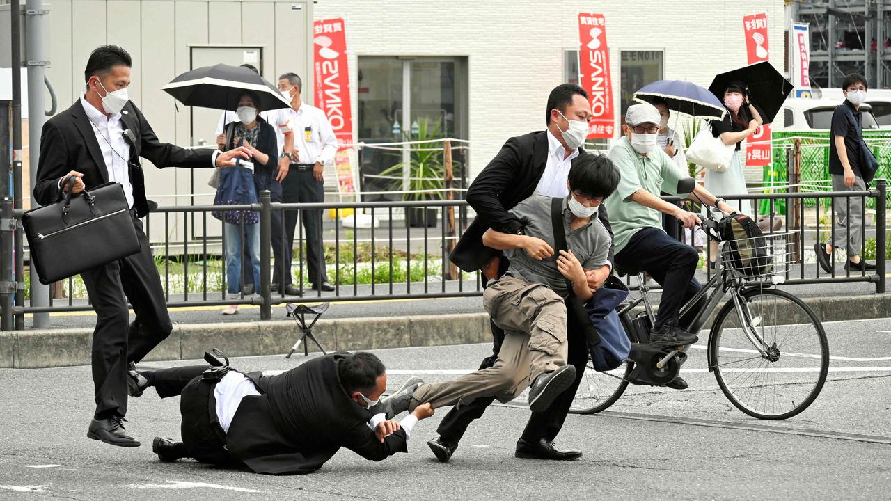 Tetsuya Yamagami being tackled to the ground by police at Yamato Saidaiji Station in the city of Nara. Picture: AFP