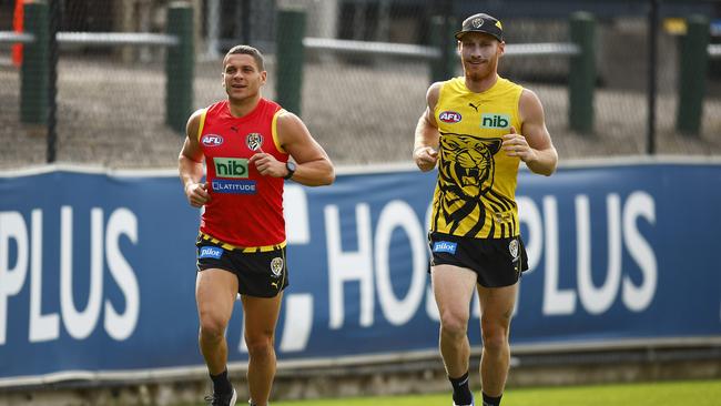 Nick Vlastuin, left with Dion Prestia, is set to return for the Tigers’ clash with Adelaide on Saturday. Picture: Getty Images