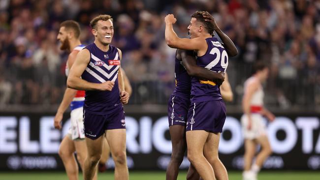 PERTH, AUSTRALIA – APRIL 27: Cooper Simpson of the Dockers celebrates a goal with Michael Frederick during the round seven AFL match between Fremantle Dockers and Western Bulldogs at Optus Stadium, on April 27, 2024, in Perth, Australia. (Photo by Paul Kane/Getty Images)