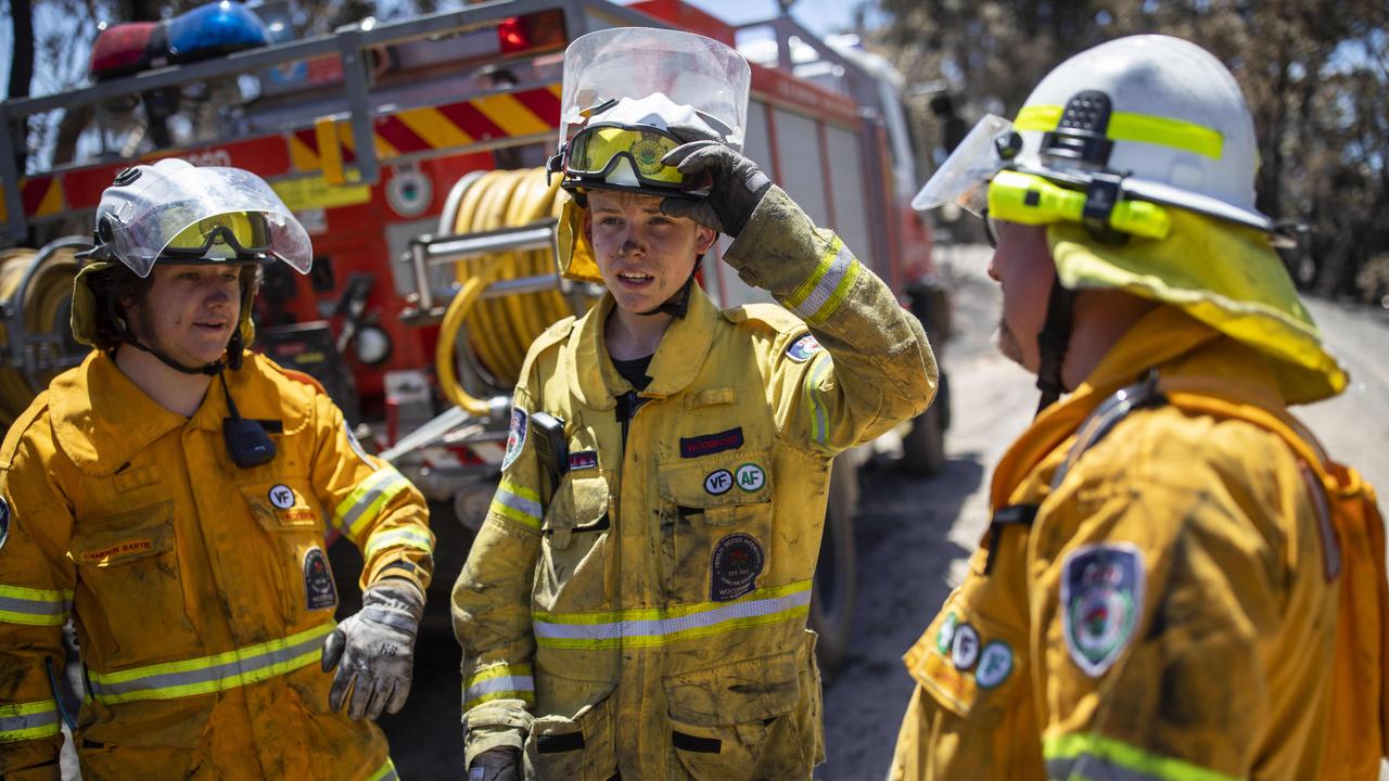 <b>CHRIS WRIGHT, 16</b> <br/> <i>Woodford Rural Fire Service,<br/>Blue Mountains, NSW<br/>Years volunteering: Four<br/></i> Fighting bushfires is something of a way of life in the thickly wooded Blue Mountains. Chris Wright has been part of his local RFS brigade since he was 12. He joined as part of the cadet program the Rural Fire Service runs in local schools. About a half-dozen of his mates did the same, and he was one of a dozen or so RFS members from his area who were on standby this week as a total fire ban was issued across seven regions in NSW. Asked why he joined the RFS, he is blunt: “My father is captain — he told me to. Plus I wanted to.” On Thursday, Wright’s crew was largely spared the drama that played out near Canberra and on the NSW south coast. “At the moment, we haven’t been called to anything and there’s nothing around the Blue Mountains.” There were advice-level fires in Blue Labyrinth, Ruin­ed Castle and Grose Valley, and an afternoon blaze threatened near Richmond. Mercifully, that was about as exciting as things got for the teen firefighter. Picture: Sean Davey.