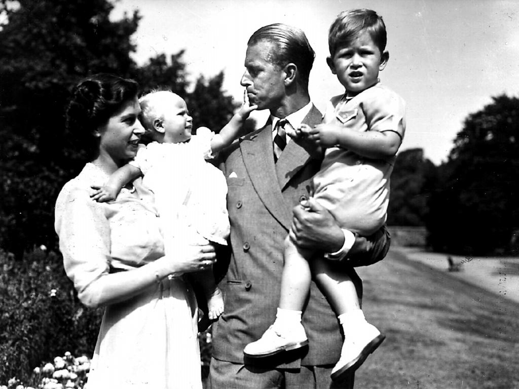 A young Charles with his parents and younger sister.