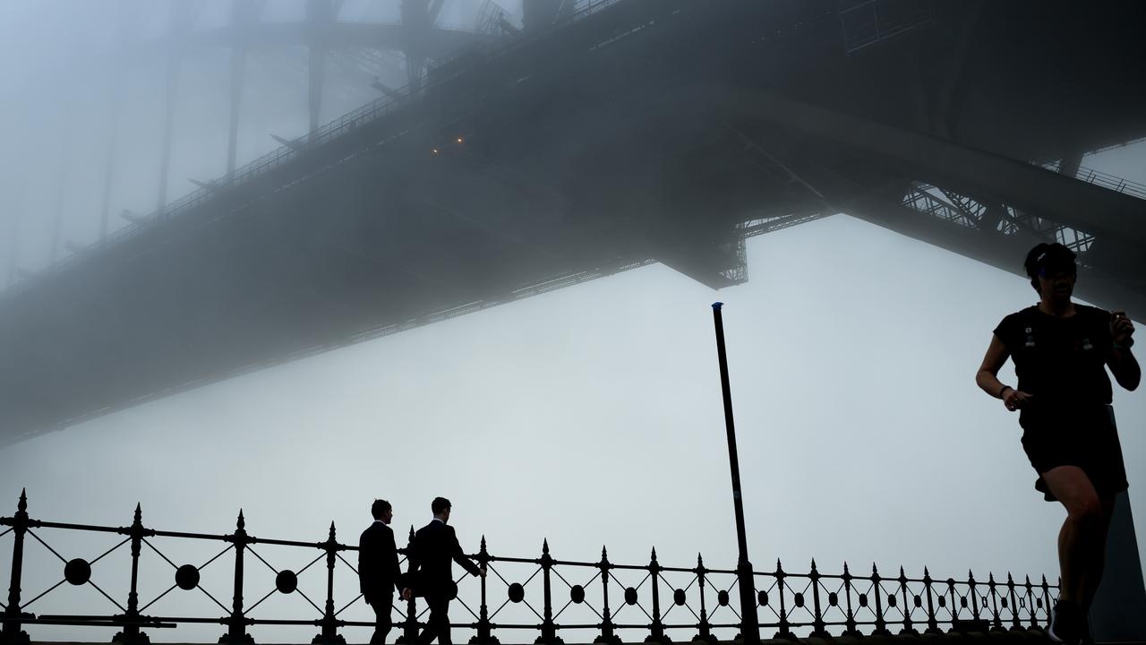 The Sydney Harbour Bridge disappears under a thick blanket of fog in Sydney, Monday.
