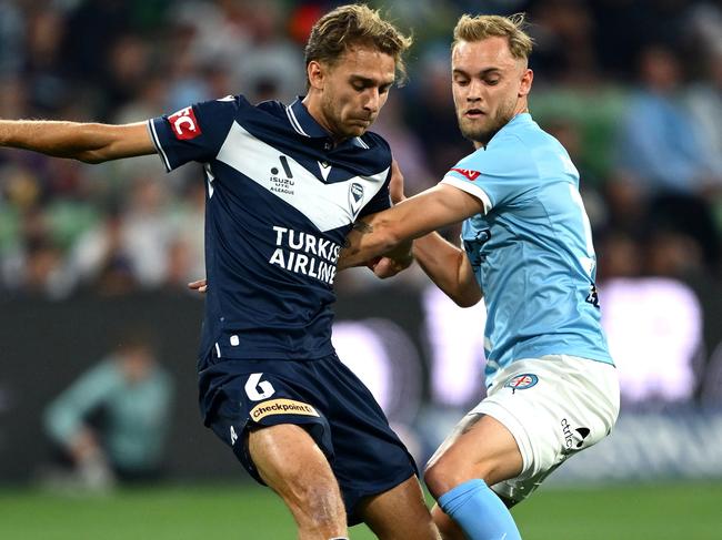 MELBOURNE, AUSTRALIA - OCTOBER 26: Ryan Teague of Melbourne Victory and Nathaniel Atkinson of Melbourne City compete for the ball during the round two A-League Men match between Melbourne City and Melbourne Victory at AAMI Park, on October 26, 2024, in Melbourne, Australia. (Photo by Quinn Rooney/Getty Images)