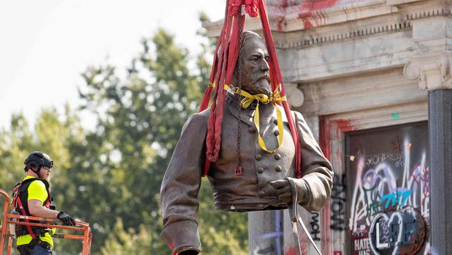 The top half of the statue of former Confederate General Robert E. Lee is lifted away after being cut off and removed from Monument Avenue in Richmond, Virginia, in September. Picture: AFP