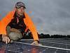  Dave Sharratt (L) and Ryan Mead installing solar panels on the roof of a home at Byford in Perth, Western Ausrtralia. 