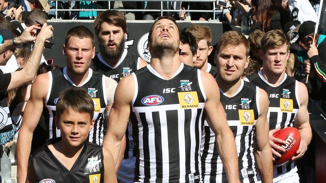 THE BLACK AND WHITE SHOW: Port Adelaide captain Travis Boak leads his side out against Richmond in the 2014 elimination final at Adelaide Oval. Picture: Sarah Reed.