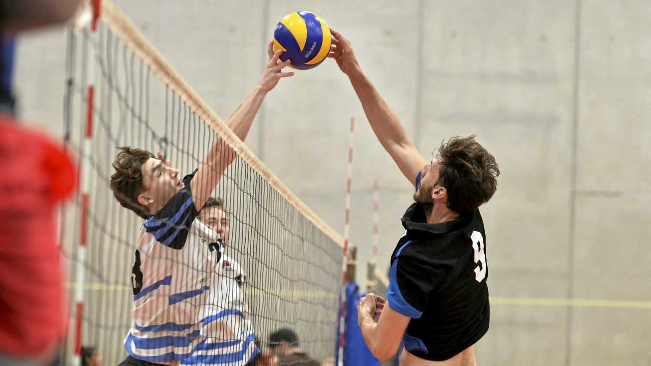 NET BATTLE: Brisbane Volleyball Club'S Connor Rudder (left) and Remember the Titans player Marco Calderini do battle at the net in the final of the Clash of the Titans volleyball tournament at Harristown State High School gym. Brisbane won the final 2-1. Picture: Kevin Farmer