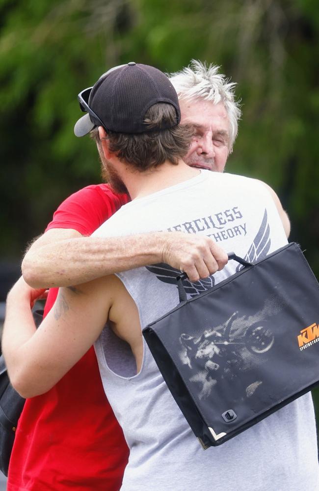 William Wilson hugs his son as they are reunited after evacuations in the area. Picture: Brendan Radke