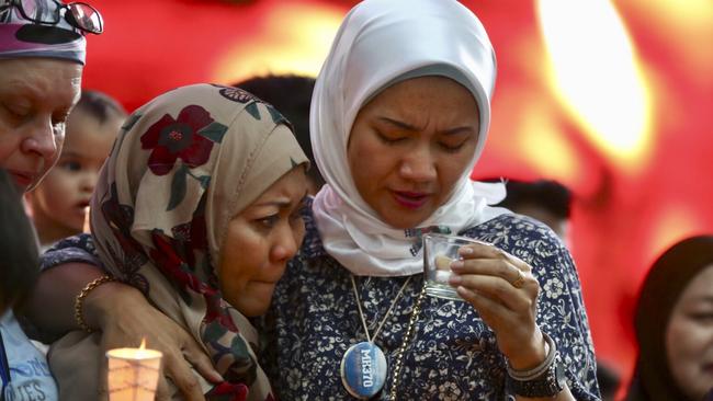 Norazlinda Ayub, left, and Intan Maizura Othaman, wife of an aircrew member of Malaysia Airlines Flight 370, embrace each other during the Day of Remembrance for MH370 event in Kuala Lumpur, Malaysia, Sunday, March 3, 2019. Picture: AP/Annice Lyn