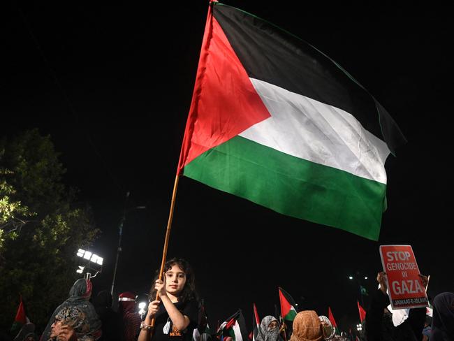 A girl holds up the Palestinian flag during a rally by Jamaat-e-Islami party supporters showing solidarity with the Palestinian people amid the ongoing battles between Israel and the militant Hamas group in the Gaza Strip, on March 31, 2024, in Karachi. (Photo by Rizwan TABASSUM / AFP)