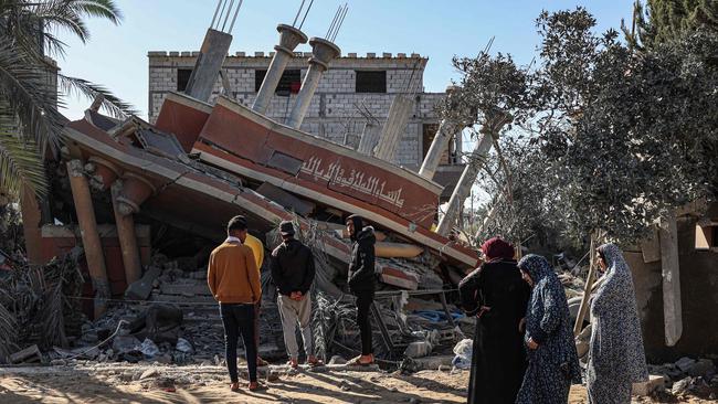 Palestinians check the rubble of the Al-Faqawi family home which was hit in an overnight Israeli air strike in Khan Yunis in the southern Gaza Strip. Picture: AFP