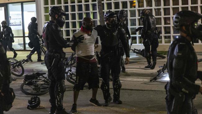 Police officers detain a protestor in Miami, Florida.