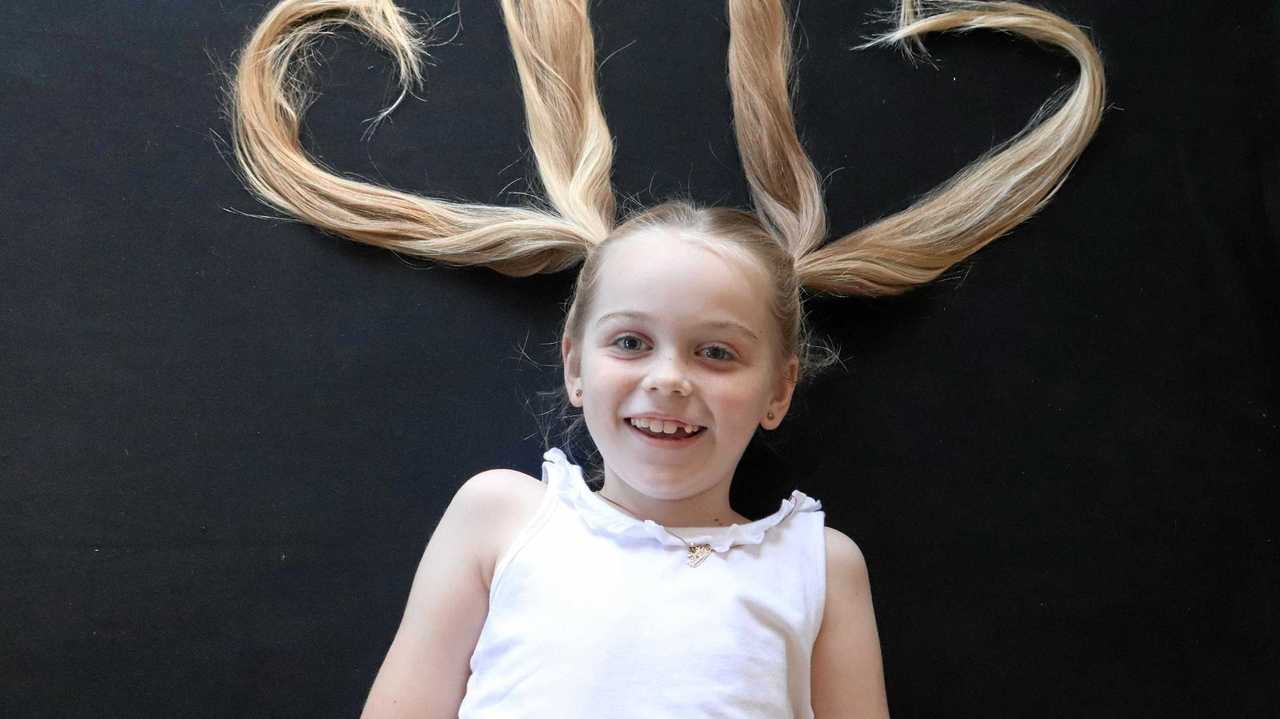 Sienna Sandoz shows off the long locks she will chop off next month to raise money for cancer research.