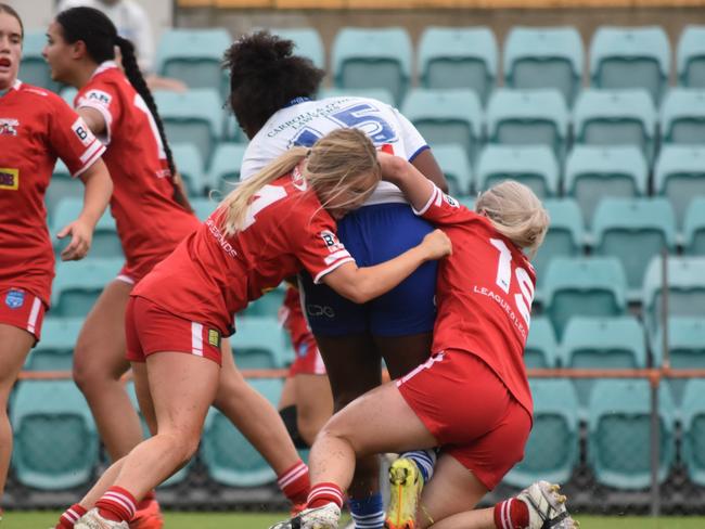 Ilisapeci Bari is tackled by Mia-Rose Walsh (left) and Ella Koster. Picture: Sean Teuma/NewsLocal