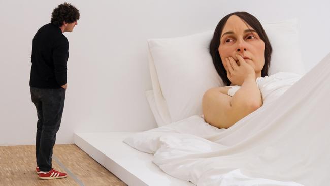 A visitor admires Ron Mueck’s 2005 sculpture “In Bed” at the Triennale di Milano, showcasing the Australian artist’s hyperrealistic artistry. Picture: Giuseppe Cottini/Getty Images