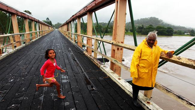 Harold Connors with his grandkids Hayley Phillips (7) look at the swelling of the Clarence River on a bridge on the Bruxner Highway near Tabulam, Northern New South Wales this afternoon which has experienced heavy rain and flash flooding. The town is cut off and access is limited. Pic - Sam Mooy