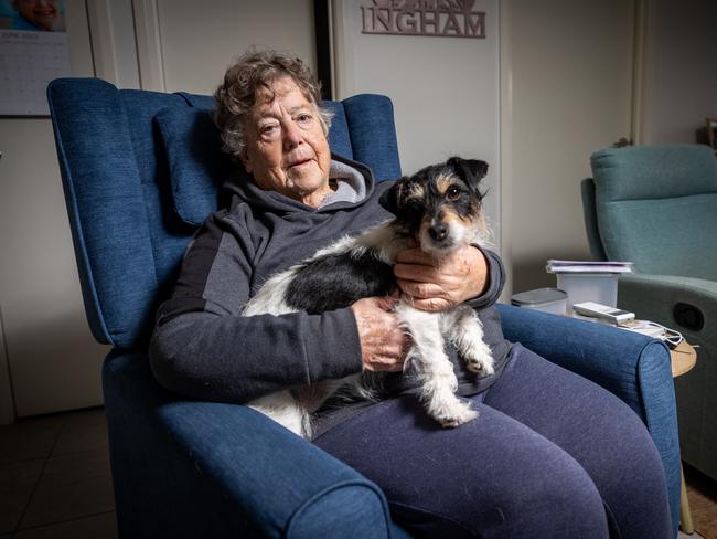 Betty May from Broadmeadows in Melbourne, with her pet dog Maggie, has cut down on heating to save on power bills. Picture: Jake Nowakowski