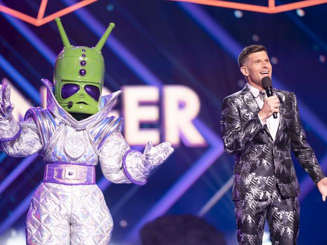 Masked Singer host Osher Gunsberg, right, with the ‘alien’ aka Nikki Webster. Picture: Ten