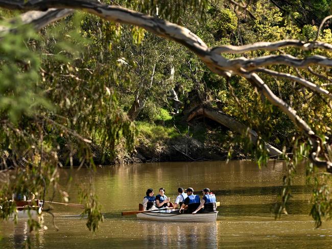 Tourists take advantage of the winter sun as they row a boat up Melbourne's Yarra River on August 19, 2024. (Photo by William WEST / AFP)