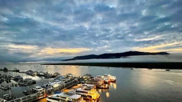 Cairns weather: After four straight days of heavy April rain, the sun is shining again, through clouds, over the Cairns Marlin Marina. Picture: Anne Massey