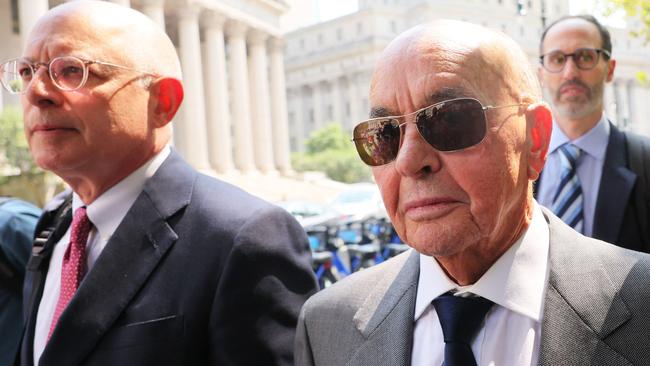 British billionaire Joe Lewis is escorted by his attorneys after leaving Manhattan Federal Court on July 26, 2023 in New York City.