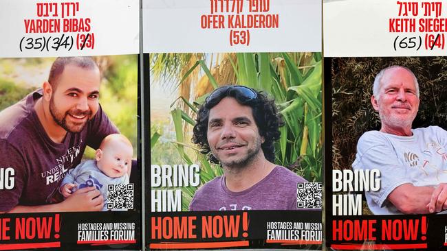 Posters of three Israeli hostages, from left, Yarden Bibas, Ofer Kalderon and Keith Siegel. Picture: AFP