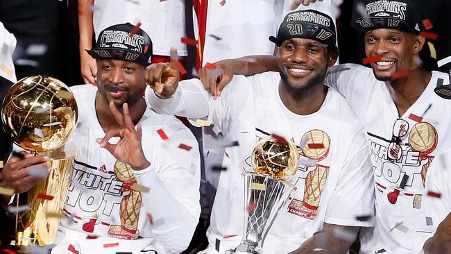 Chris Bosh (right) celebrates Miami Heat’s 2013 NBA title with Dwyane Wade and LeBron James.