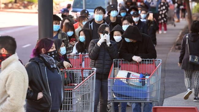 Shoppers wait in a long queue outside a Costco outlet in Melbourne on August 2, 2020 as people queue for provision with the Victorian state government expected to annouce harsh new restrictions due to the city battling fresh outbreaks of the COVID-19 coronavirus. (Photo by William WEST / AFP)
