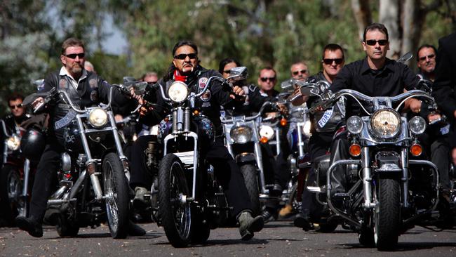 Rebels MC National President Alex Vella leads the procession into the cemetery to lay Rebel Rick to rest.