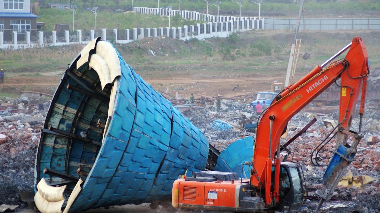 Chinese workers demolish the ruins of some fairytale castles at the Beijing Wonderland Amusement Park in China. Picture: Imaginechina Limited / Alamy