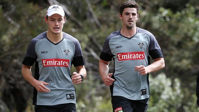 Scott Pendlebury runs with Darcy Moore at Collingwood’s Falls Creek training camp. Picture: Michael Klein