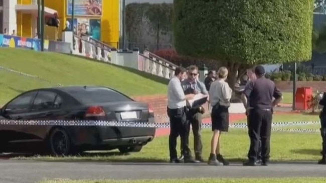 A black commodore has crashed into the Dreamworld entrance in suspected road rage incident. Picture: Nine News