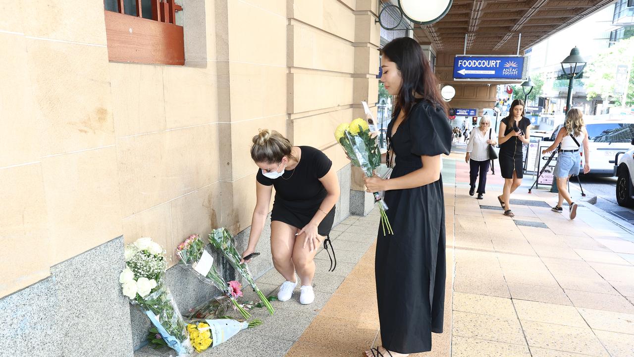 Minh Phan, the owner of Milash, leaves flowers where an 18-year-old woman was killed by an out-of-control bus in Brisbane's CBD on Friday. Picture: Supplied